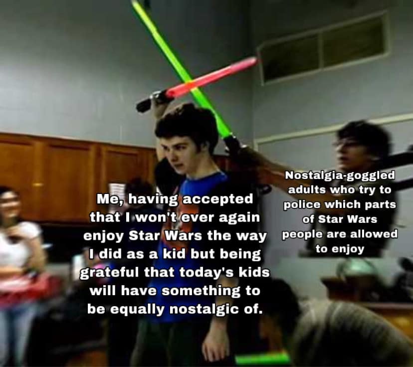 This meme is a humorous comparison between two groups of people. The image is of a group of adults, likely in a meeting or conference setting, who are dressed in business attire and holding lightsabers. The text reads: "Me, having accepted that I'll never be a Jedi, but being grateful that my kids will have that experience."